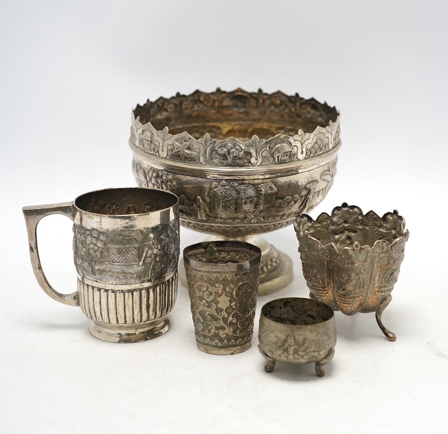 An Indian repousse white metal pedestal bowl, diameter 15.5cm (a.f.), a similar mug, small vase, condiment and small beaker. Condition - poor to fair